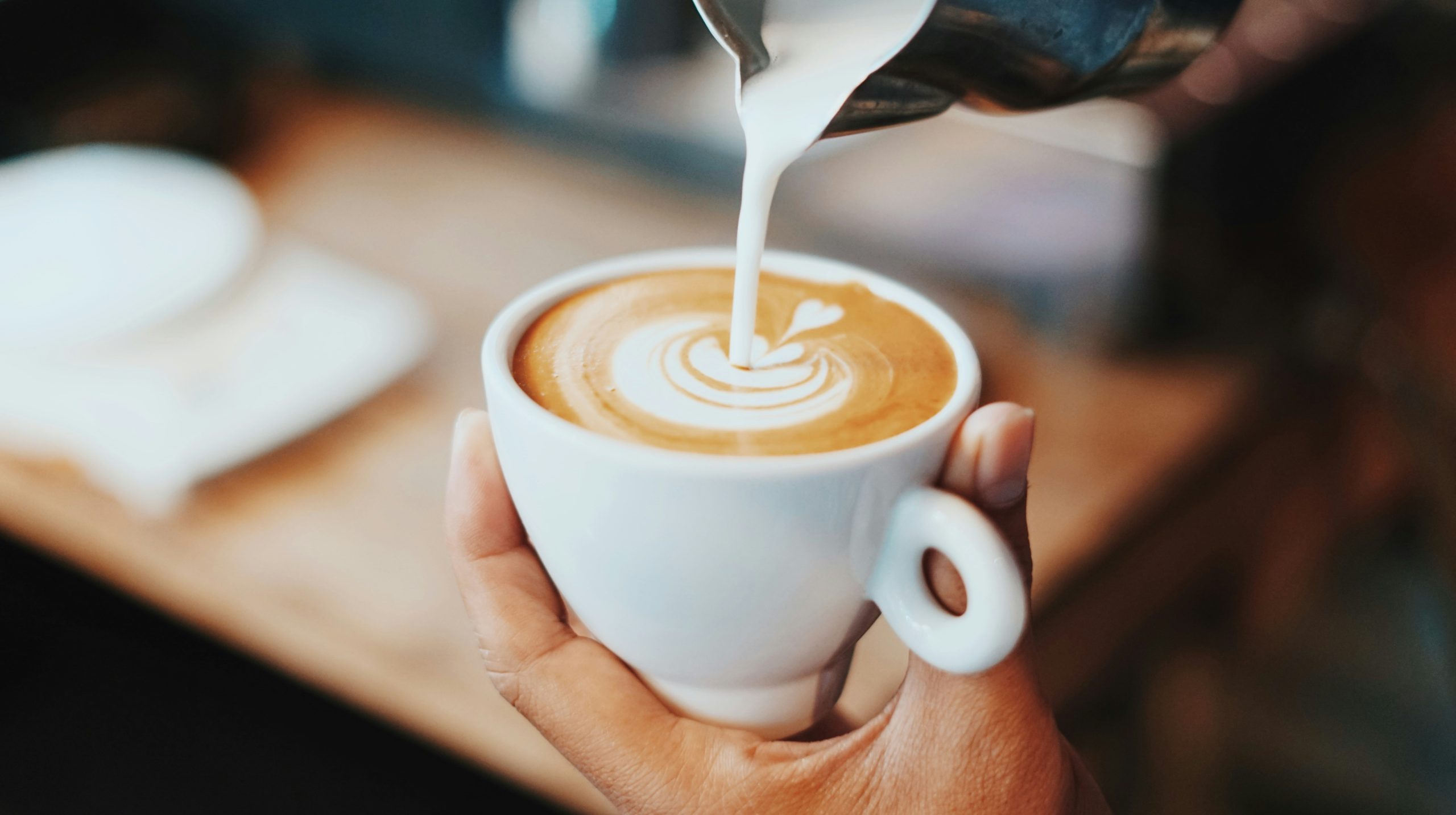 Milk being poured into a coffee